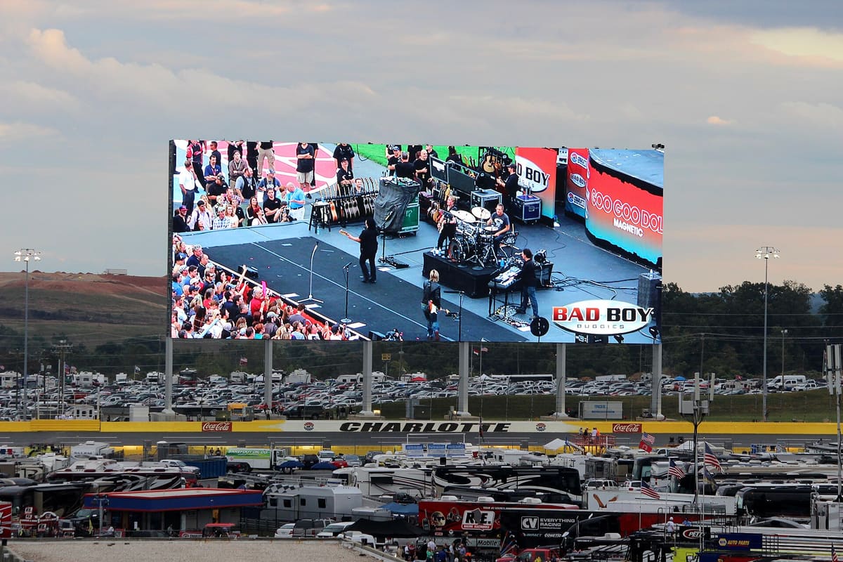 Giant LED video screen above the stands of a motor-racing stadium
